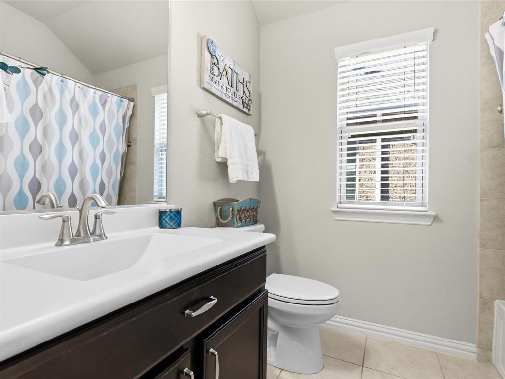419 George Drive Fate, TX 75189 - Photo 22 of 26 a bathroom with a sink a toilet and a window