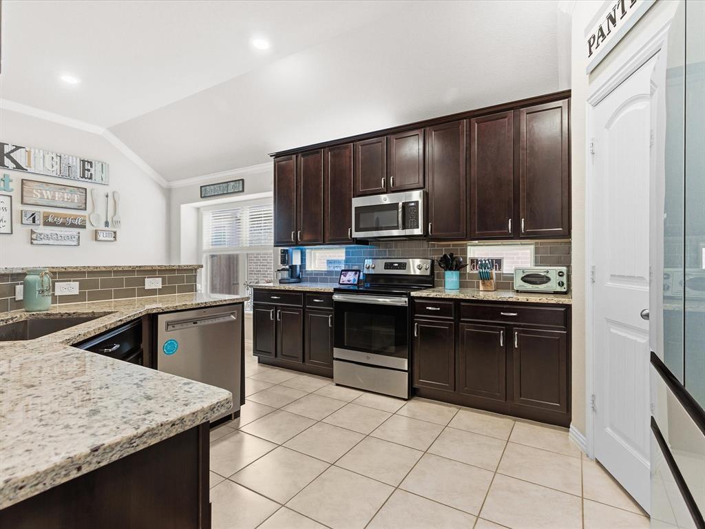 419 George Drive Fate, TX 75189 - Photo 7 of 26 a kitchen with a sink stove and microwave