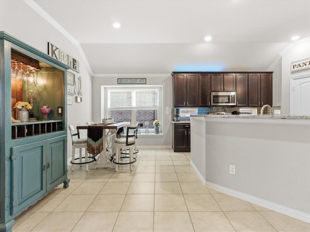 419 George Drive Fate, TX 75189 - Photo 10 of 26 a kitchen with stainless steel appliances a stove a sink a microwave a refrigerator and cabinets