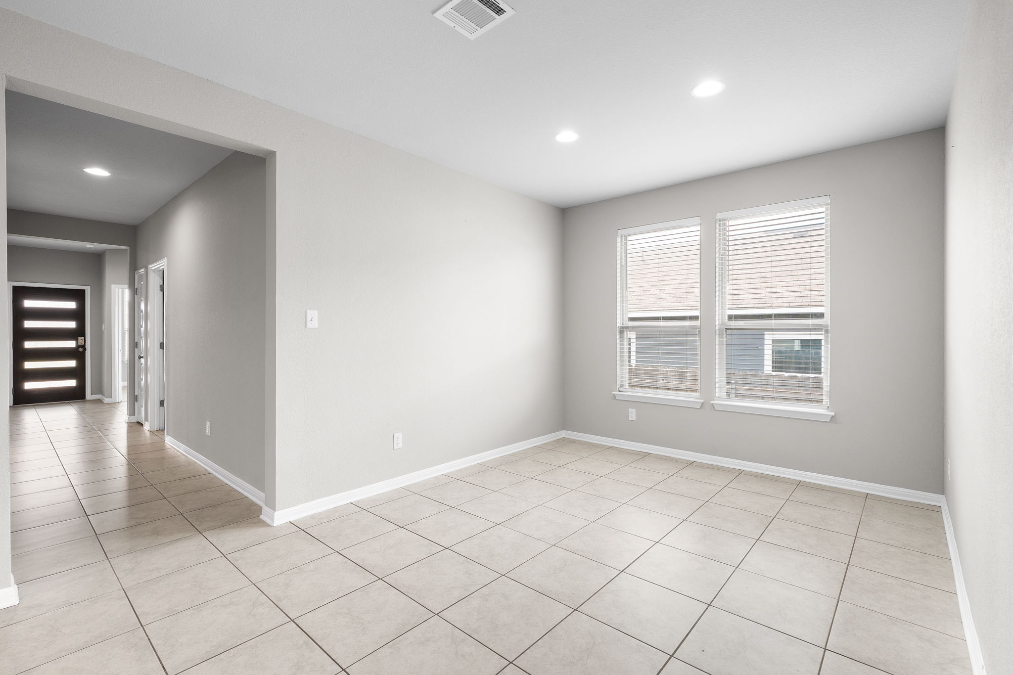 313 Mclintock Road Jarrell, TX 76537 - Photo 13 of 40 A versatile living space with sleek tiled floors and sun-filled windows invites personalized design.