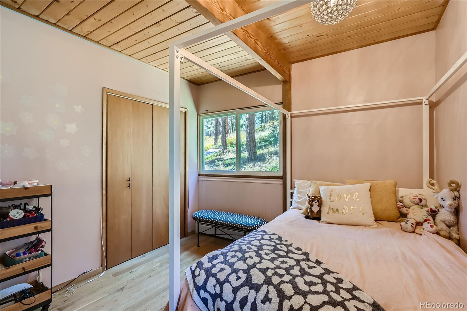 938 Valley Road Evergreen, CO 80439 - Photo 11 of 24 a bedroom with a bed and a window
