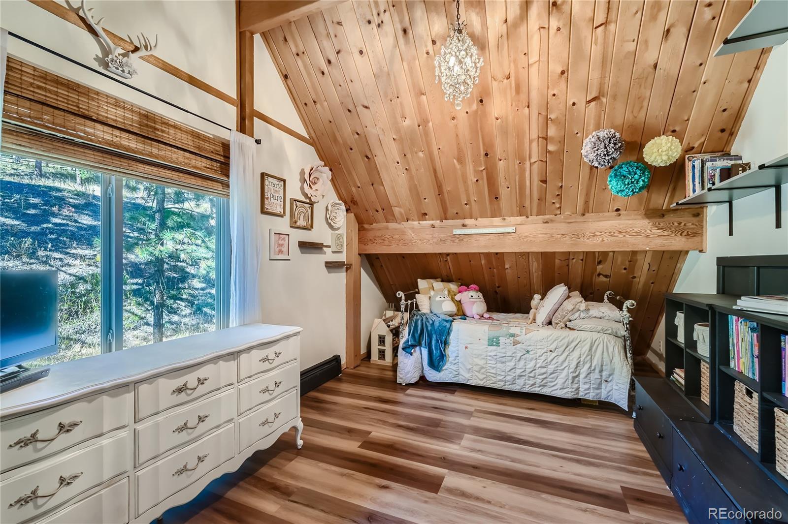 938 Valley Road Evergreen, CO 80439 - Photo 18 of 24 a bedroom with a bed and a window