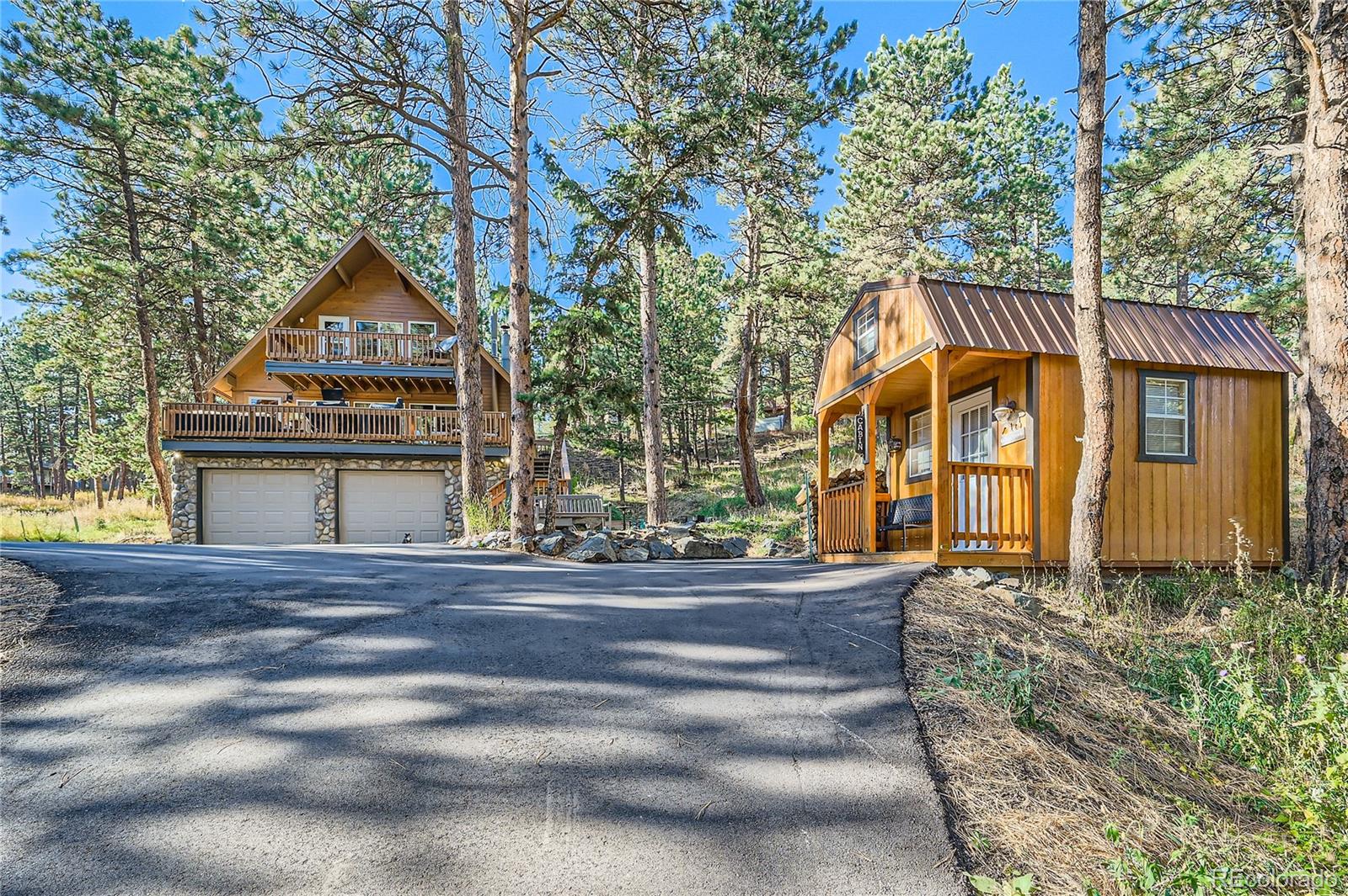 938 Valley Road Evergreen, CO 80439 - Photo 2 of 24 a front view of a house with garden