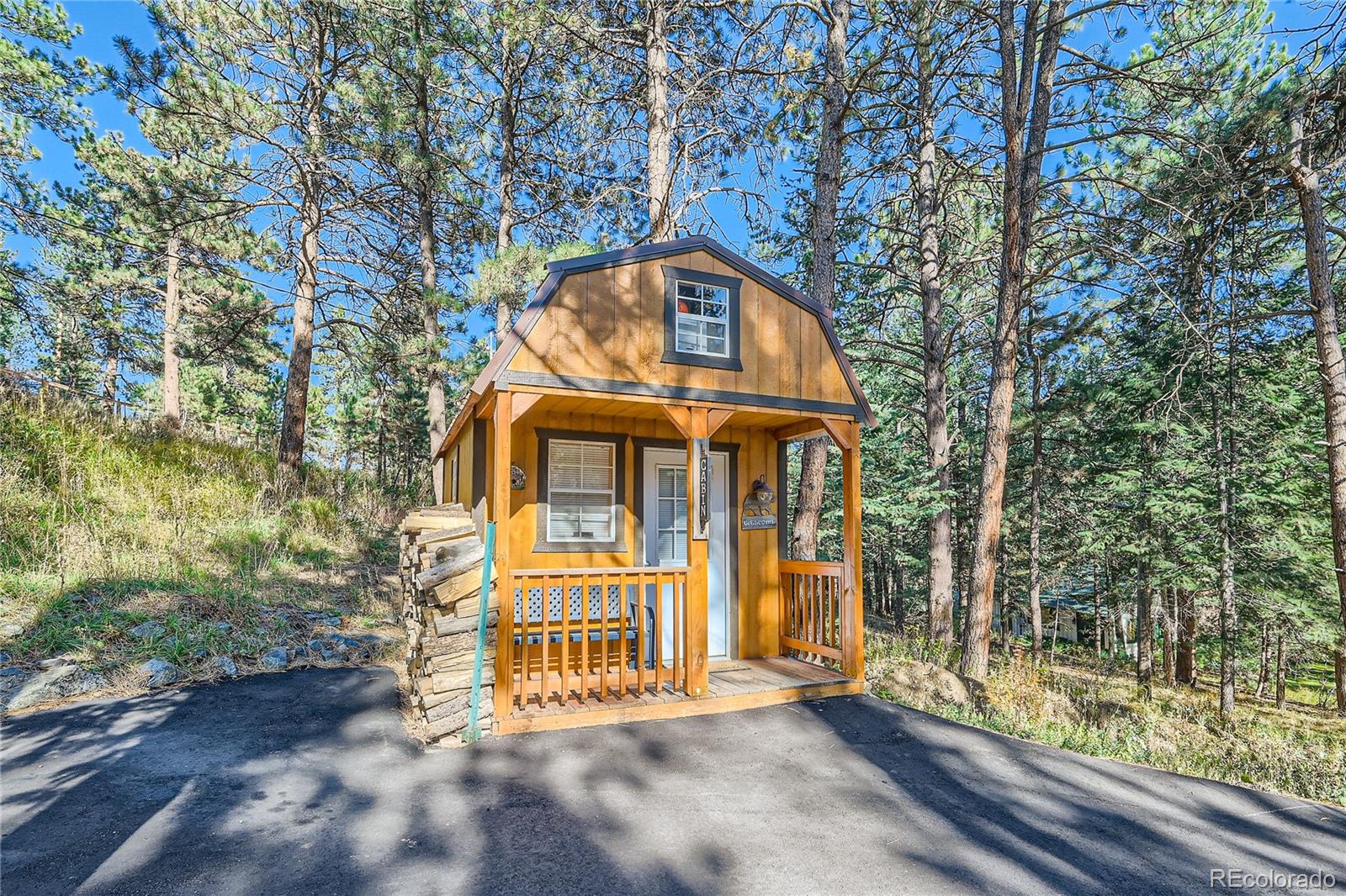 938 Valley Road Evergreen, CO 80439 - Photo 21 of 24 a front view of a house with a yard