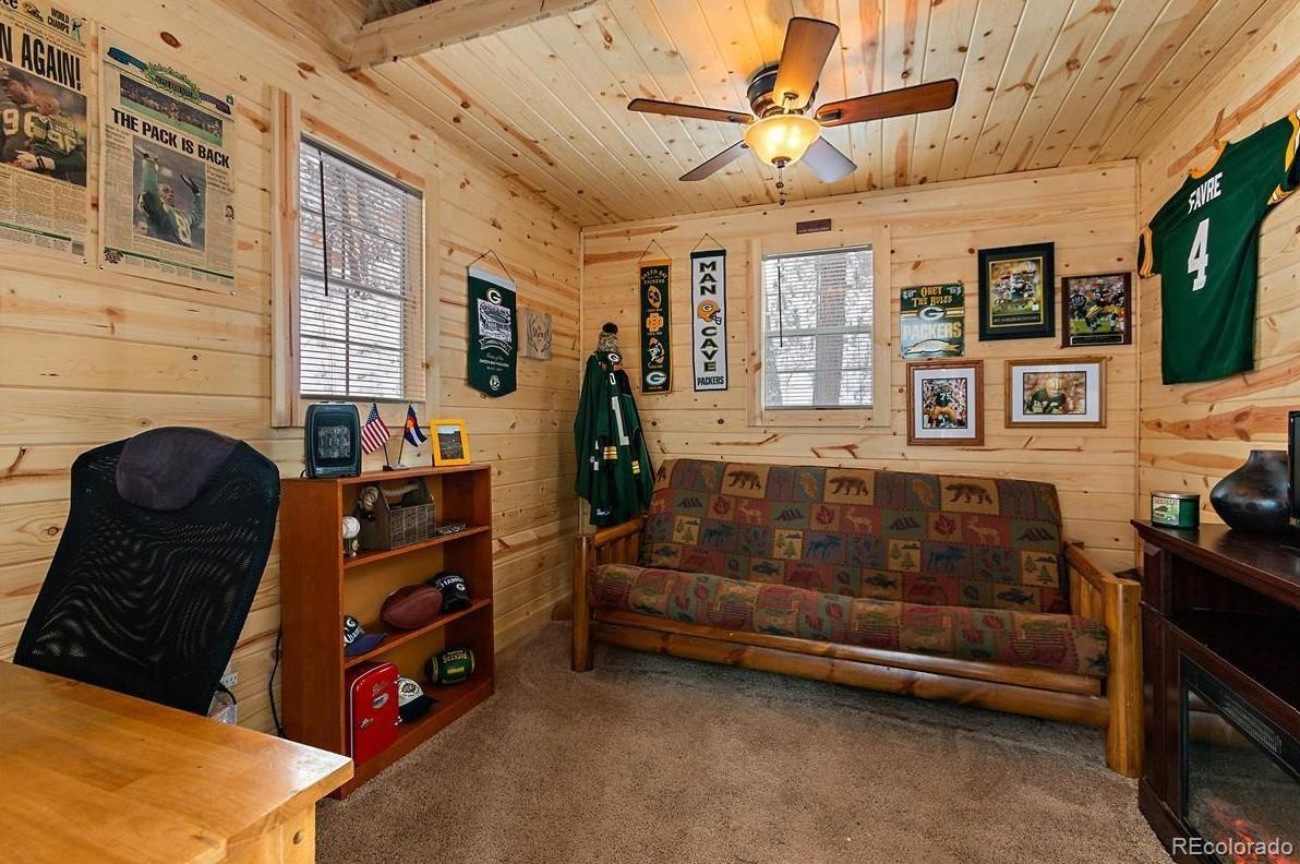 938 Valley Road Evergreen, CO 80439 - Photo 22 of 24 a living room with furniture and a window