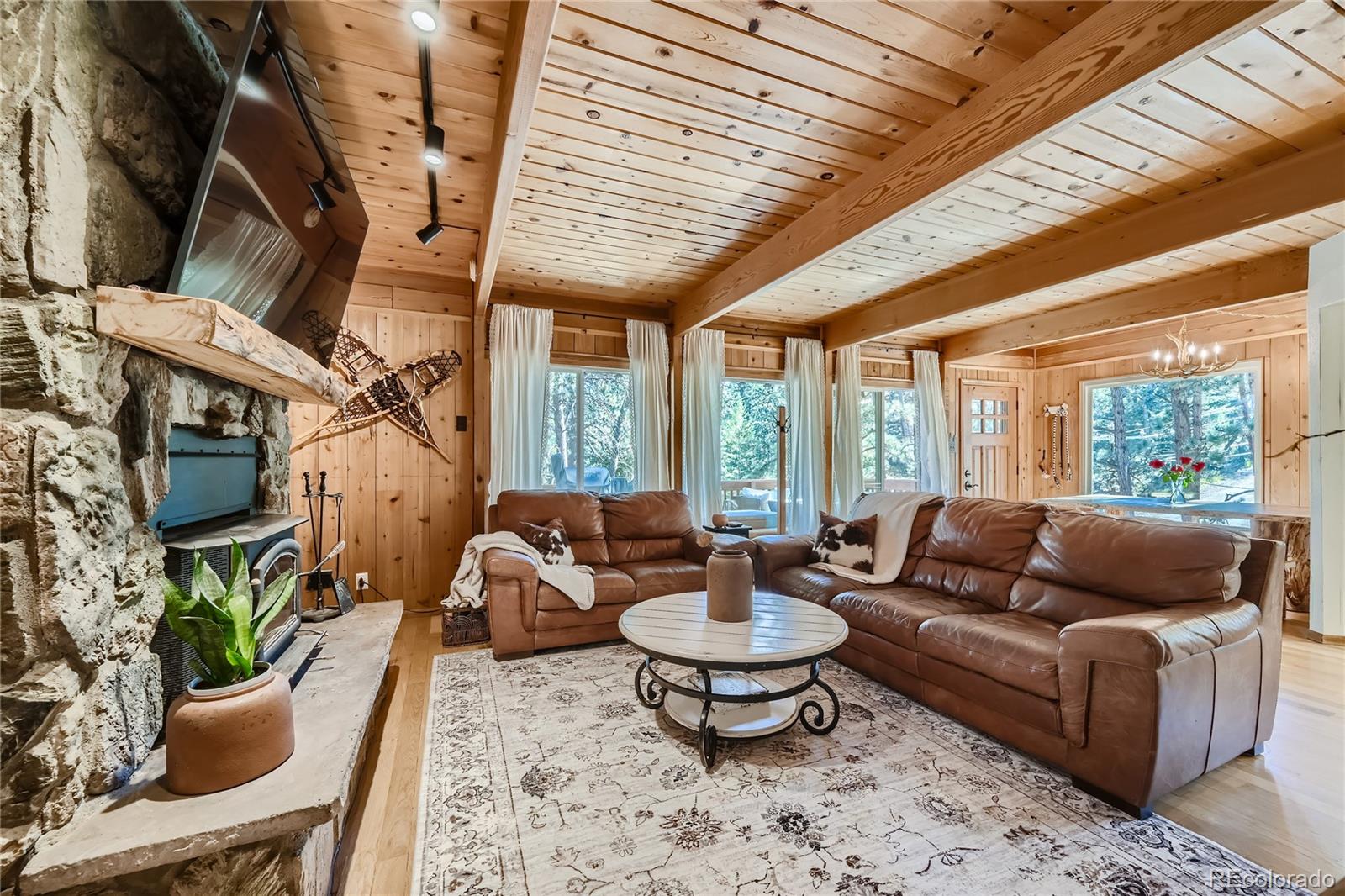 938 Valley Road Evergreen, CO 80439 - Photo 6 of 24 a living room with furniture and a floor to ceiling window