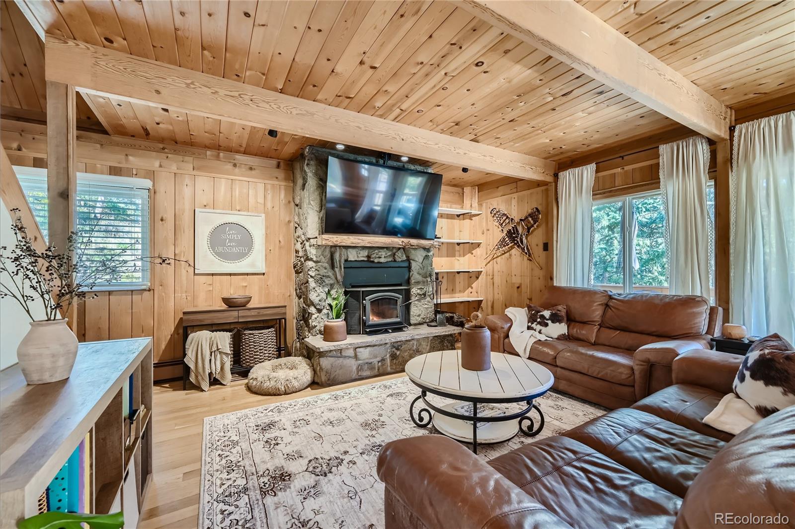 938 Valley Road Evergreen, CO 80439 - Photo 7 of 24 a living room with furniture and a fireplace