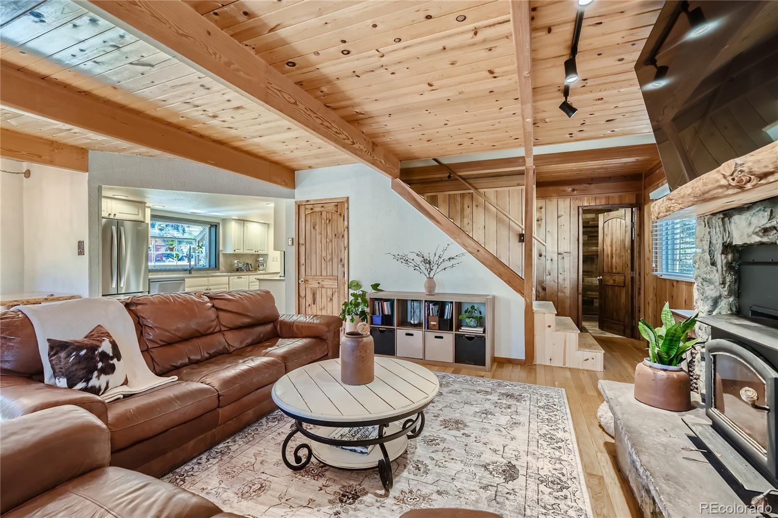 938 Valley Road Evergreen, CO 80439 - Photo 8 of 24 a living room with furniture and a dining table