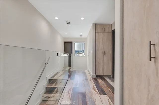 a view of hallway with wooden floor