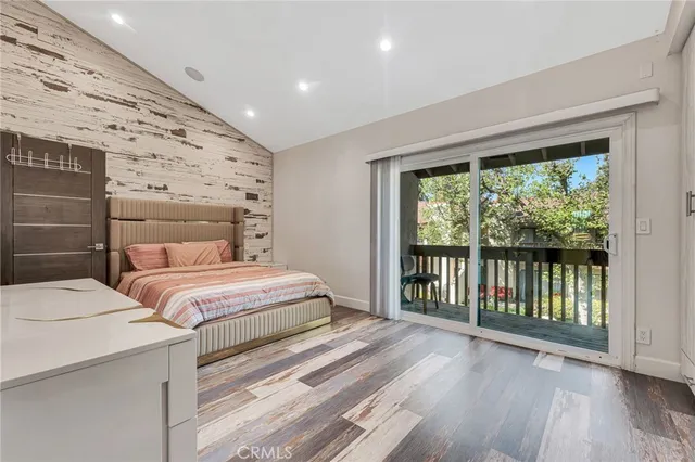 a bedroom with a large bed and a large window