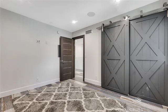 a view of walk in closet with a rug