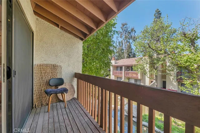 a view of a balcony with chairs