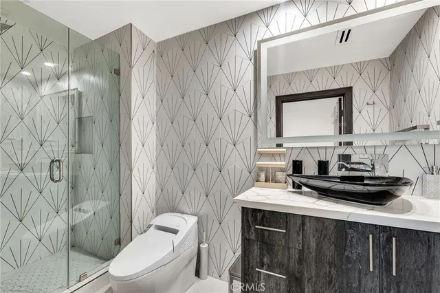 a bathroom with a sink a toilet and shower