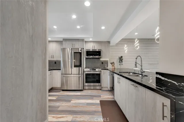 a kitchen with a sink stainless steel appliances and cabinets