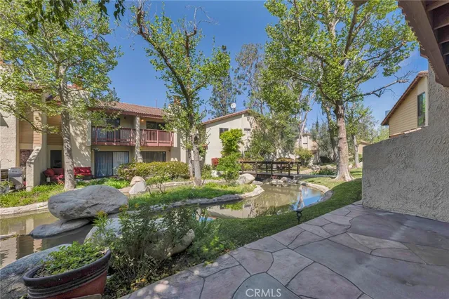 a view of a fountain in front of a brick house