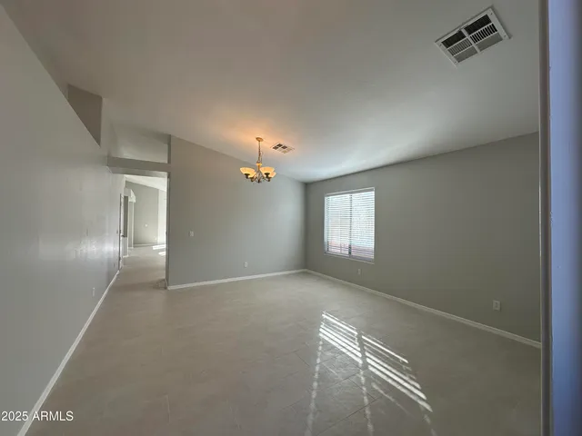 an empty room with windows and entrance