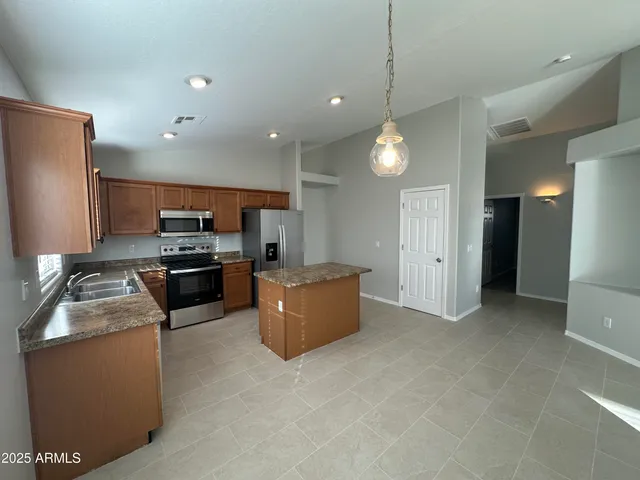 a kitchen with refrigerator and microwave