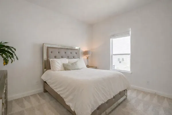 a bedroom with a bed and a window
