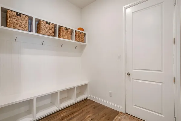 a view of an empty room with wooden floor