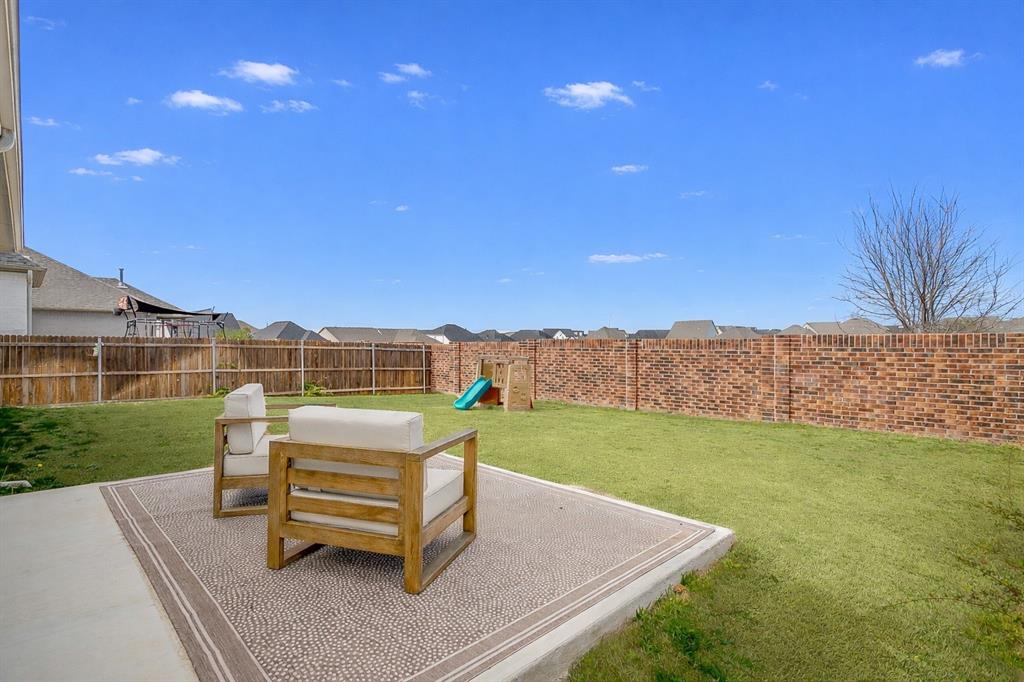 208 Observation Drive West Aledo, TX 76008 - Photo 23 of 23 a view of a backyard with lawn chairs with wooden fence