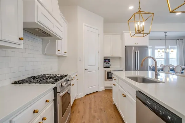 a kitchen that has a sink and a stove in it