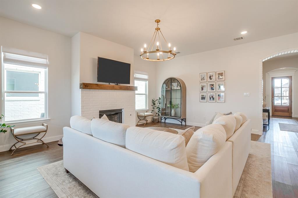 208 Observation Drive West Aledo, TX 76008 - Photo 8 of 23 a living room with furniture a fireplace and a chandelier
