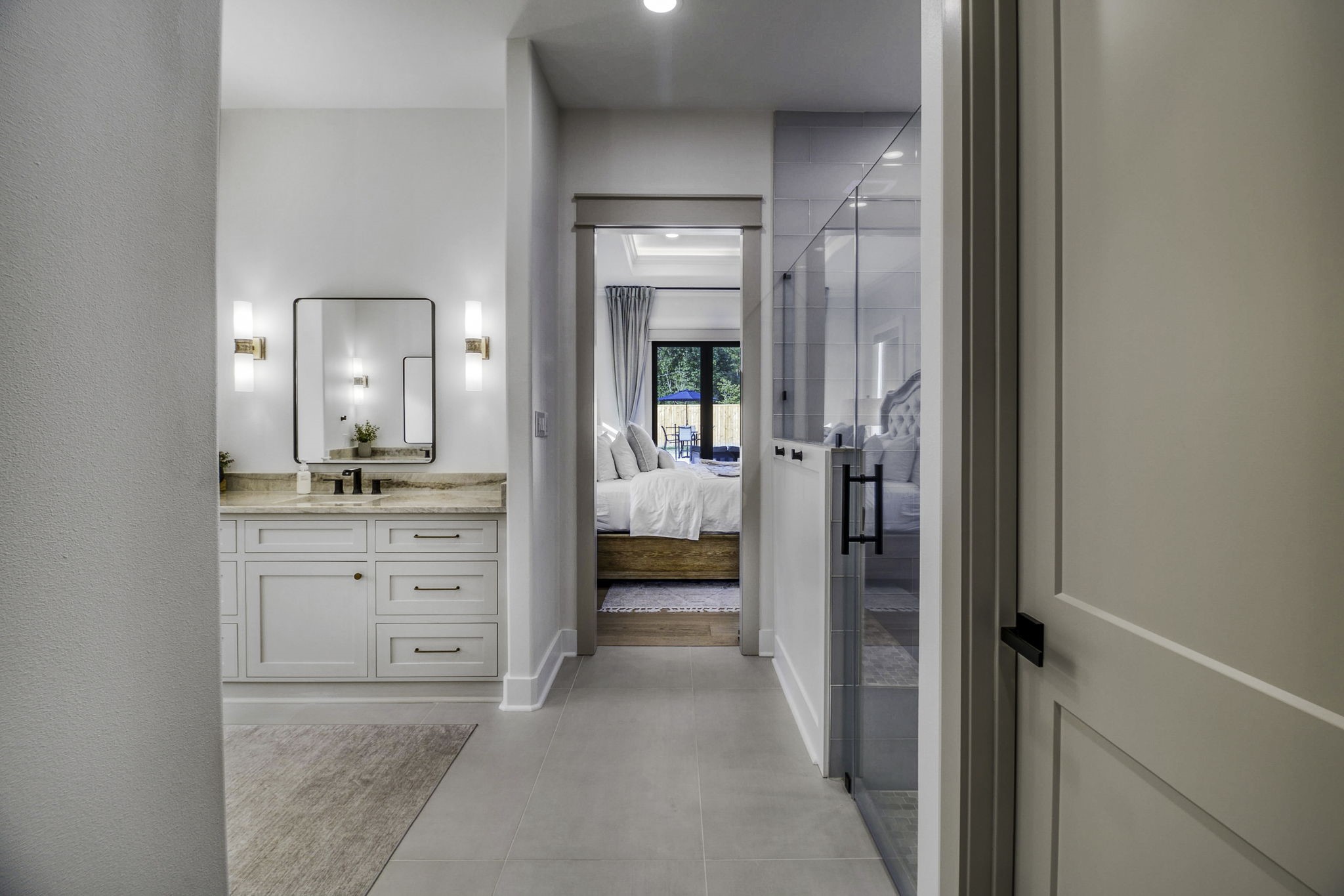 4602 Fm 3459 Road Onalaska, TX 77360 - Photo 25 of 45 a en suite bathroom with a sink a mirror and a shower
