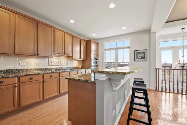 a kitchen with counter top space and wooden floor