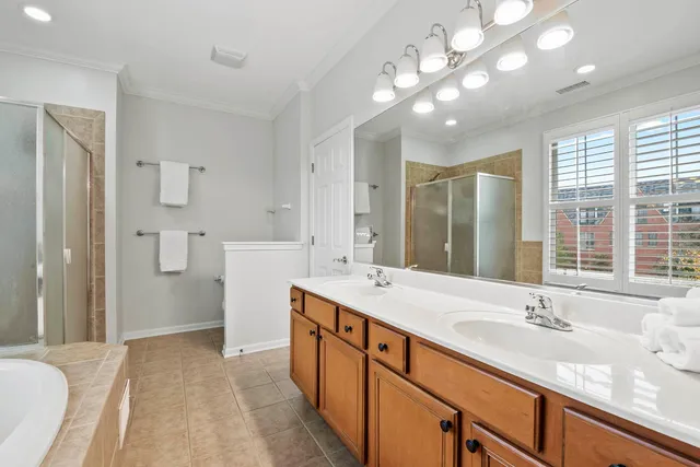 a spacious bathroom with a sink double vanity granite and a shower