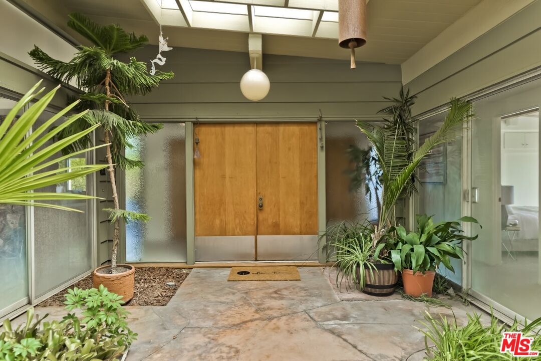 1126 Tellem Drive Pacific Palisades, CA 90272 - Photo 11 of 46 a view of a house with a potted plant