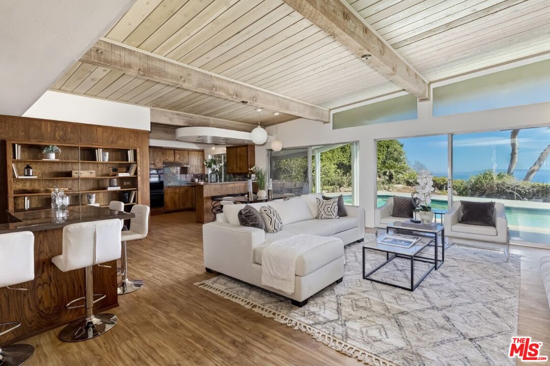 1126 Tellem Drive Pacific Palisades, CA 90272 - Photo 12 of 46 a living room with furniture and a table