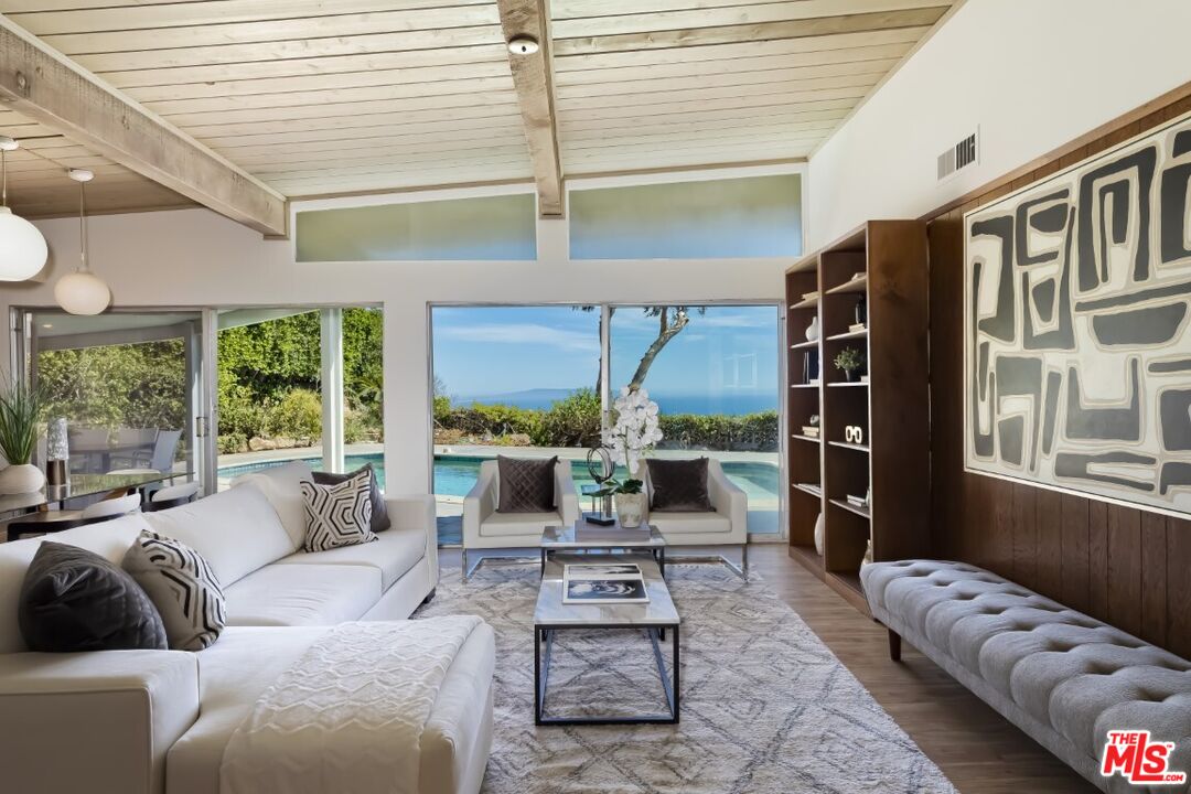 1126 Tellem Drive Pacific Palisades, CA 90272 - Photo 13 of 46 a living room with furniture and a large window