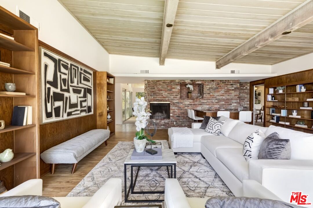 1126 Tellem Drive Pacific Palisades, CA 90272 - Photo 15 of 46 a living room with furniture a fireplace and a table