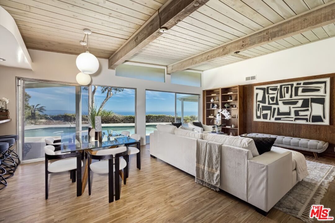 1126 Tellem Drive Pacific Palisades, CA 90272 - Photo 17 of 46 a living room with fireplace furniture and a large window