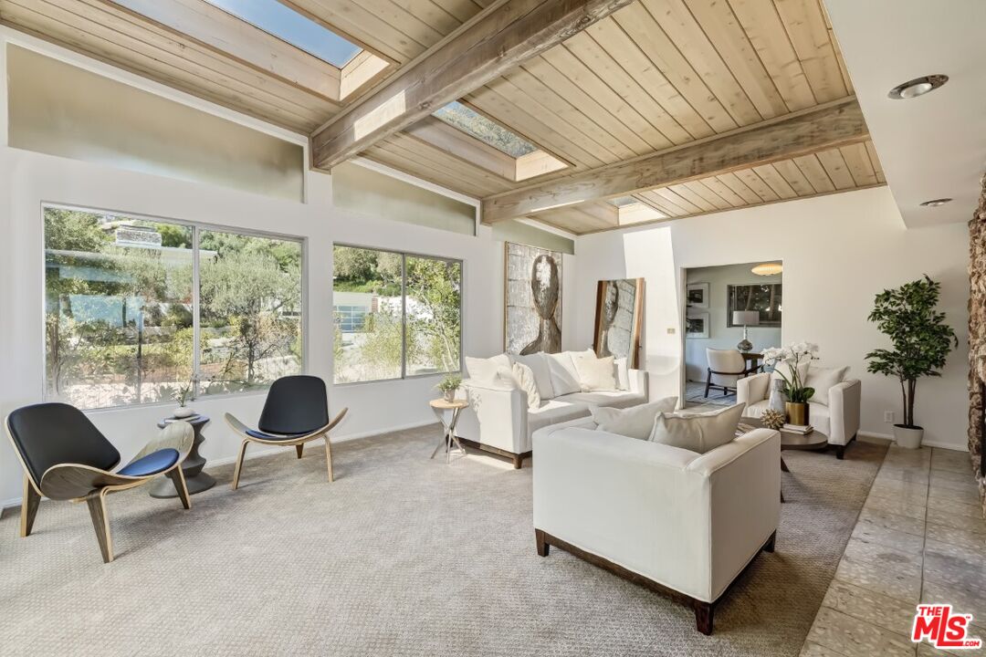 1126 Tellem Drive Pacific Palisades, CA 90272 - Photo 22 of 46 a living room with furniture and a large window