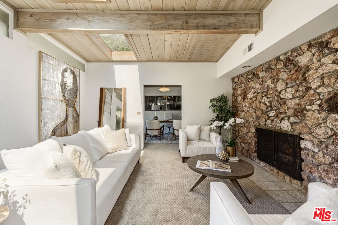 1126 Tellem Drive Pacific Palisades, CA 90272 - Photo 23 of 46 a living room with furniture and a fireplace