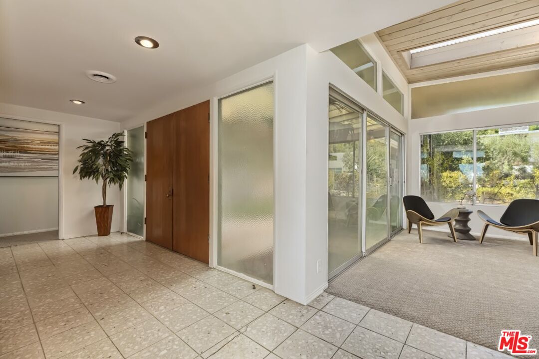 1126 Tellem Drive Pacific Palisades, CA 90272 - Photo 26 of 46 a view of a livingroom with furniture and floor to ceiling window