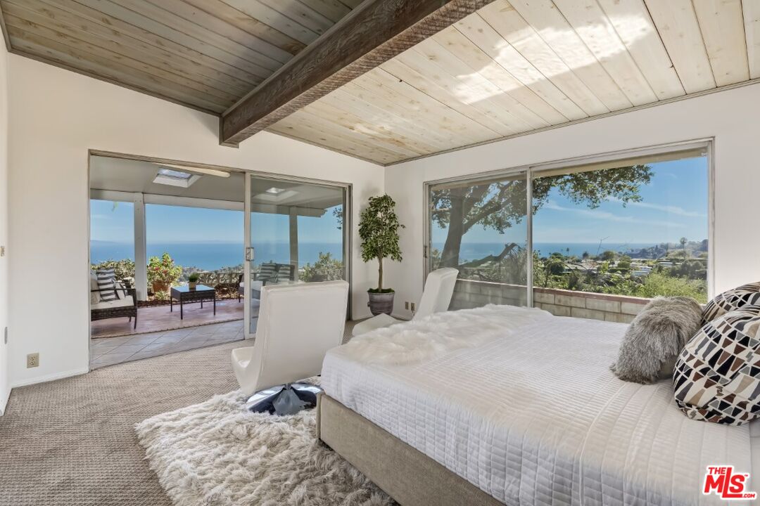 1126 Tellem Drive Pacific Palisades, CA 90272 - Photo 30 of 46 a bed sitting in a bedroom next to a window