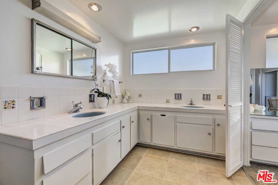 1126 Tellem Drive Pacific Palisades, CA 90272 - Photo 34 of 46 a spacious bathroom with a sink and a mirror
