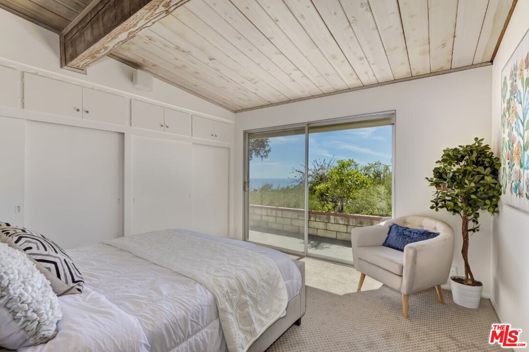 1126 Tellem Drive Pacific Palisades, CA 90272 - Photo 35 of 46 a bedroom with a bed and a potted plant