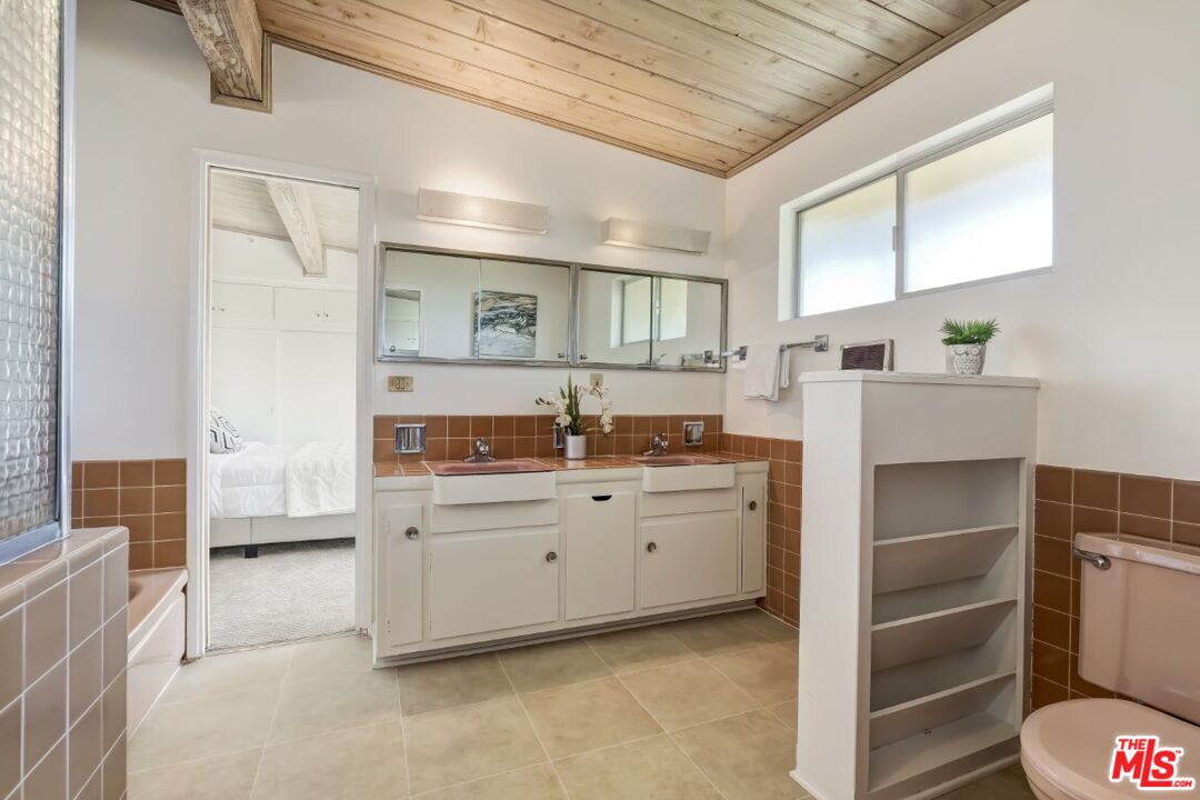 1126 Tellem Drive Pacific Palisades, CA 90272 - Photo 36 of 46 a kitchen with granite countertop a sink and a stove