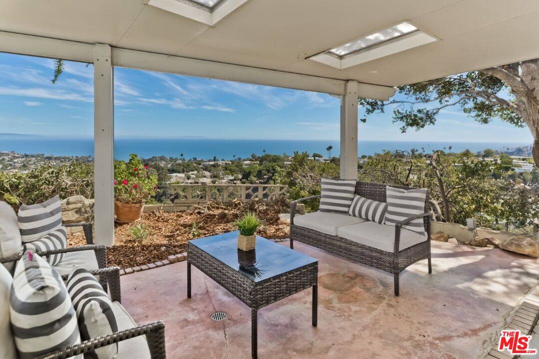 1126 Tellem Drive Pacific Palisades, CA 90272 - Photo 39 of 46 a living room with furniture and a floor to ceiling window