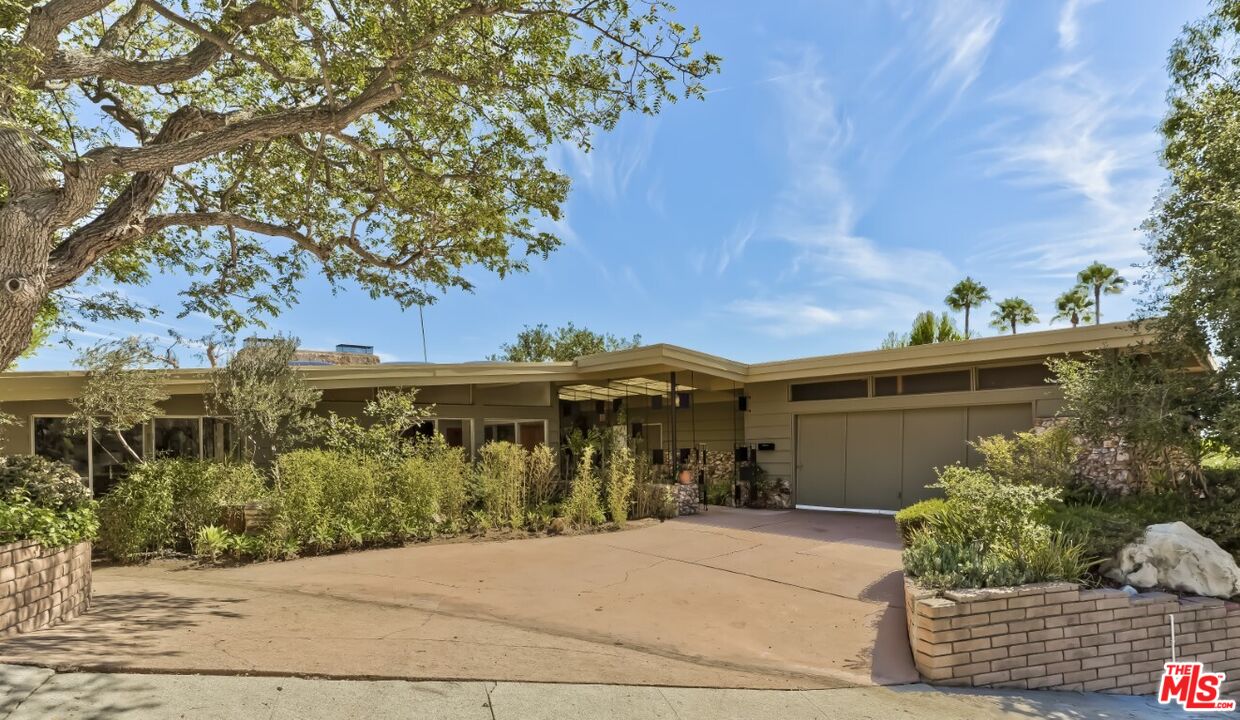 1126 Tellem Drive Pacific Palisades, CA 90272 - Photo 9 of 46 front view of a house with a tree