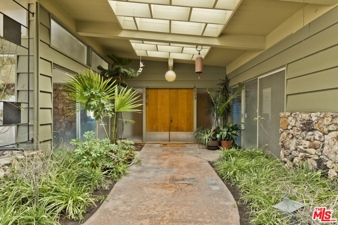 1126 Tellem Drive Pacific Palisades, CA 90272 - Photo 10 of 46 a front view of a house with a porch