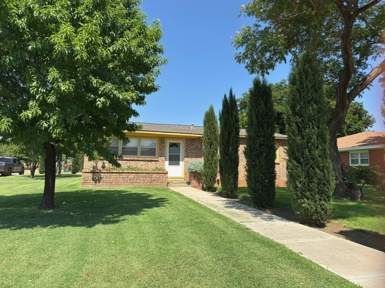 a front view of house with yard and green space