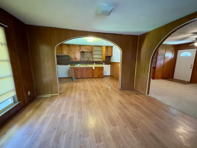 a view of a hallway with wooden floor