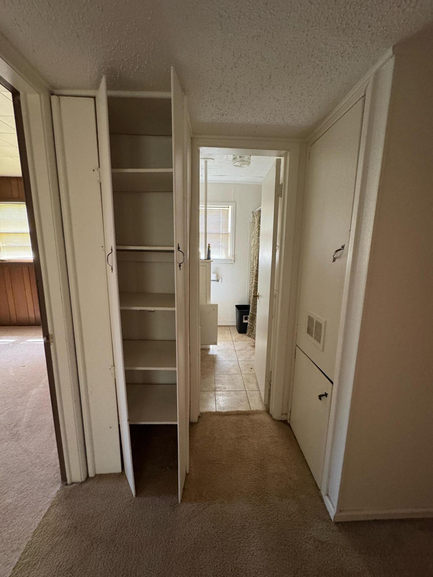 955 South 20th Street Slaton, TX 79364 - Photo 10 of 14 a view of walk in closet with empty tub