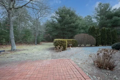 a backyard of a house with barbeque oven and barbeque oven