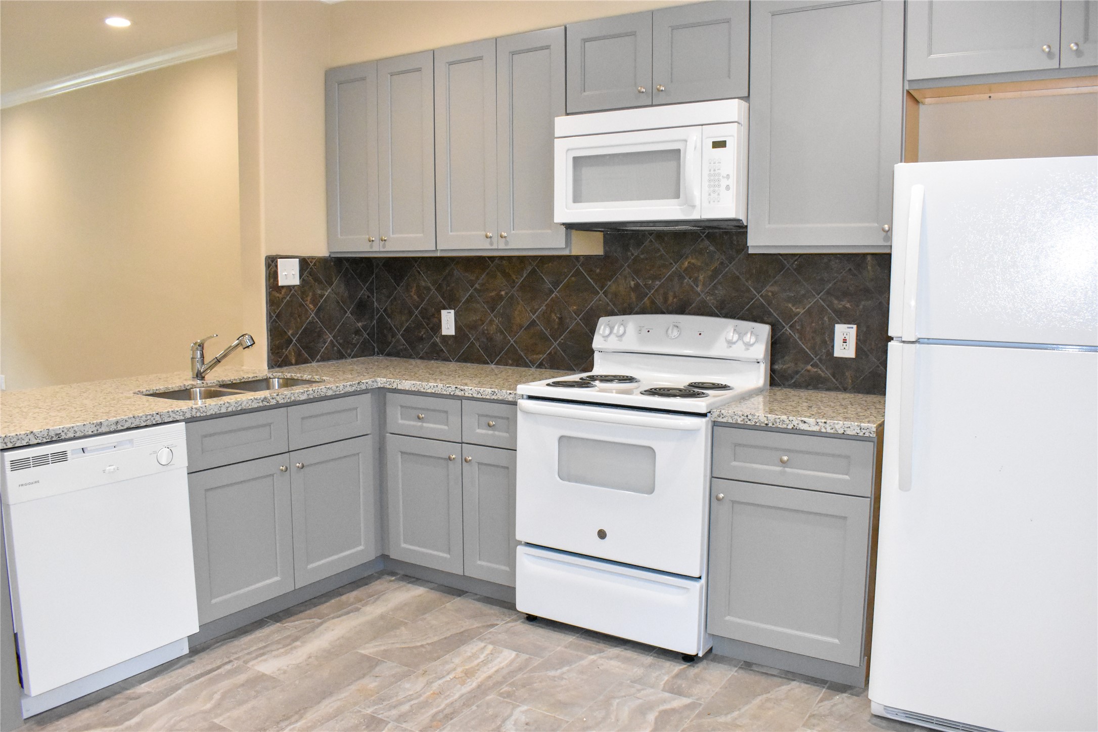 a kitchen with white cabinets and white appliances