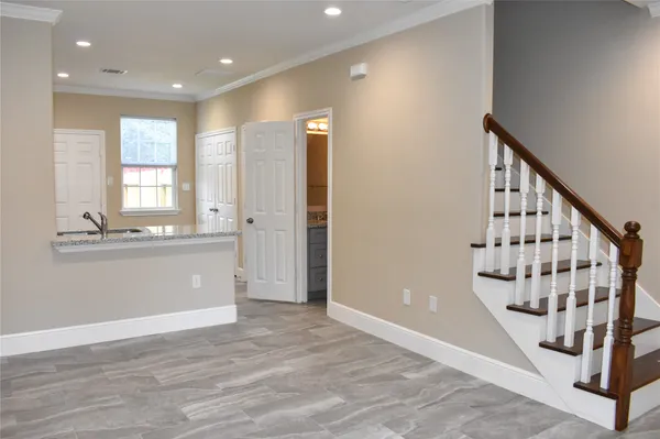 a view of an entryway with wooden floor and staircase